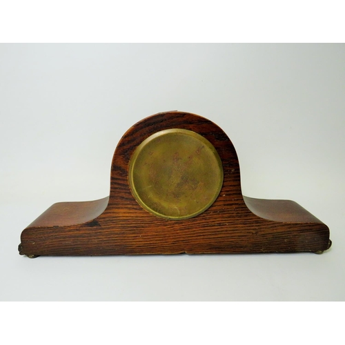 43 - Oak cased mantle clock with ornate carving to the base. Brass mechanism in running order. Measures 1... 