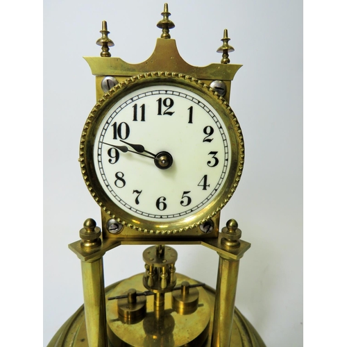 47 - German made brass Anniversary clock under Glass dome. Appears to be in running order.  Small piece m... 