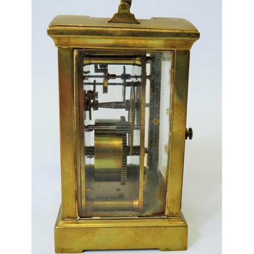 54 - Brass Carriage clock with glass panels and door. Enamel dial. Working order. (small amount of damage... 