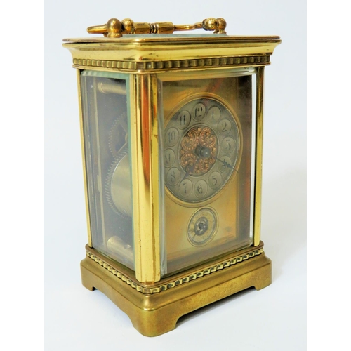 55 - Brass Carriage clock with alarm,  glass panels and door. Enamel dial. Working order.   Requires key.... 