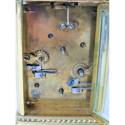 55 - Brass Carriage clock with alarm,  glass panels and door. Enamel dial. Working order.   Requires key.... 