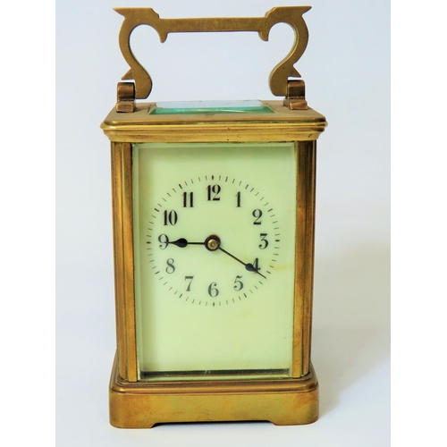 56 - Brass Carriage Clock with enamel face. Glass panels and door.  Running order, requires key.  5 inche... 