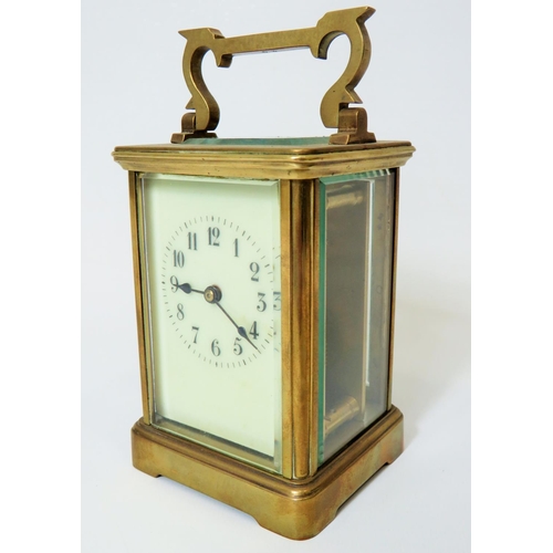 56 - Brass Carriage Clock with enamel face. Glass panels and door.  Running order, requires key.  5 inche... 