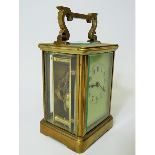 56 - Brass Carriage Clock with enamel face. Glass panels and door.  Running order, requires key.  5 inche... 