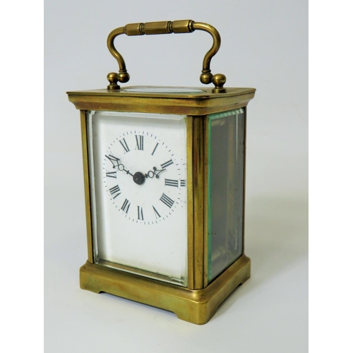 57 - Brass Carriage Clock with enamel face. Glass panels and door. Makers or Retailers mark of ACC  Runni... 