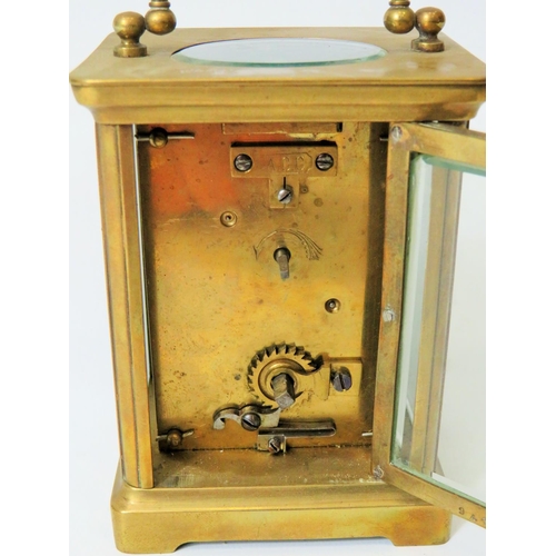 57 - Brass Carriage Clock with enamel face. Glass panels and door. Makers or Retailers mark of ACC  Runni... 