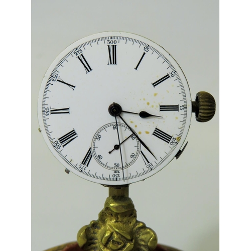 60 - Unusual enamel faced Pocket watch which has been mounted on a brass and wooden stand and under a gla... 