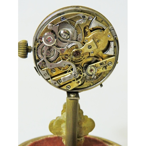 60 - Unusual enamel faced Pocket watch which has been mounted on a brass and wooden stand and under a gla... 