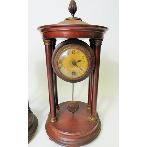 63 - Matched pair of mantle clocks with Mahogany cases and exposed pendulums.  Bun feet with Acorn final ... 