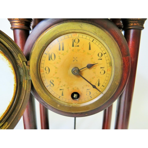 63 - Matched pair of mantle clocks with Mahogany cases and exposed pendulums.  Bun feet with Acorn final ... 