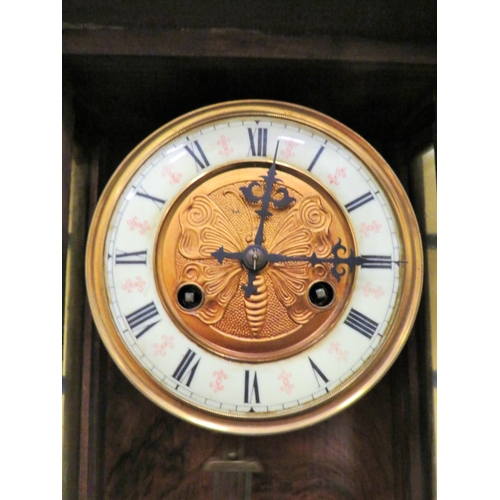 67 - Oak Wall clock in running order wih Key Enamel and brass pendulum with impressed image of a butterfl... 