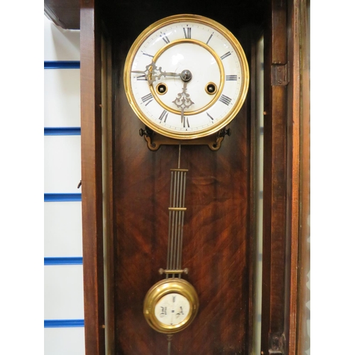 69 - Oak Cased Wall Clock with enamel dial in working order.  38 inches long. See photos.