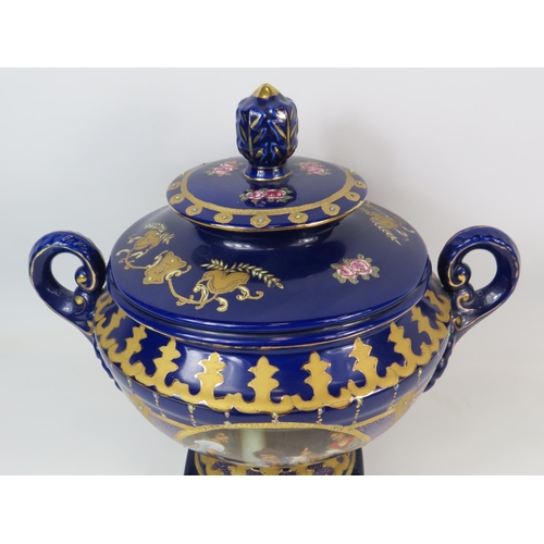 124 - Large Royal Limoge blue and gold twin handle lidded urn vase with panels dipicting girls on a balcon... 