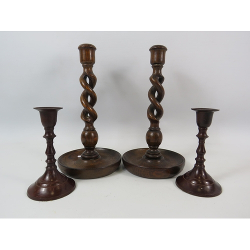 320 - Pair of Oak twisted candle sticks 25cm tall plus a pair of bronzed candlesticks 14cm tall.