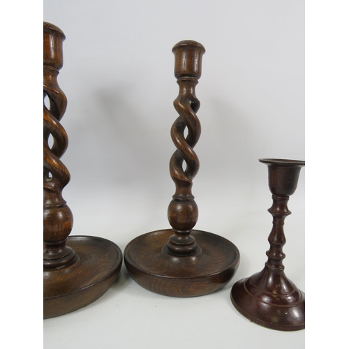 320 - Pair of Oak twisted candle sticks 25cm tall plus a pair of bronzed candlesticks 14cm tall.