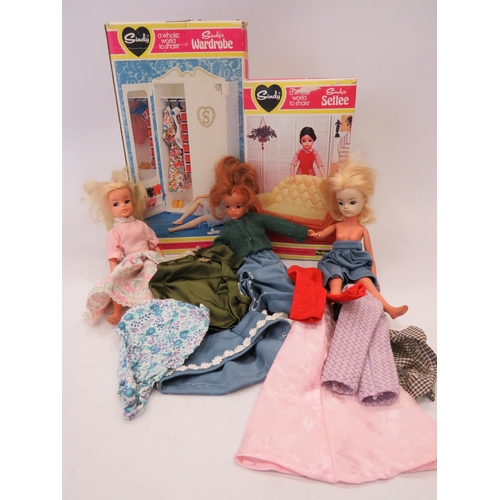 Three Vintage Sindy Dolls with assorted clothes along with a Boxed