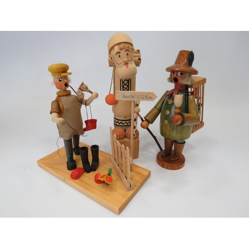 589 - Three German made wooden novelty toys,  Smoking shoe seller, Smoking flute model plus one other figu... 