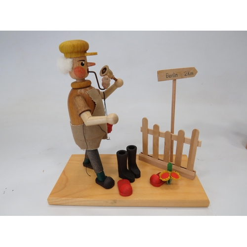 589 - Three German made wooden novelty toys,  Smoking shoe seller, Smoking flute model plus one other figu... 