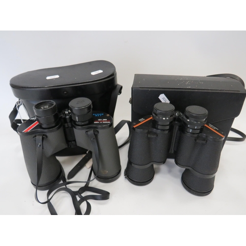 696 - Two pairs of 10 x 50 Binoculars by Prinz & Swift, both come with hard carry cases. See photos.