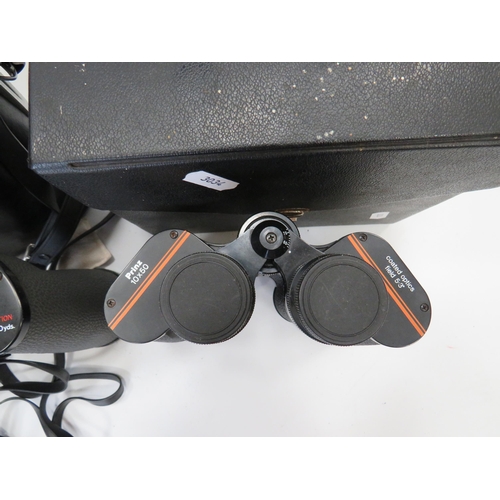 696 - Two pairs of 10 x 50 Binoculars by Prinz & Swift, both come with hard carry cases. See photos.