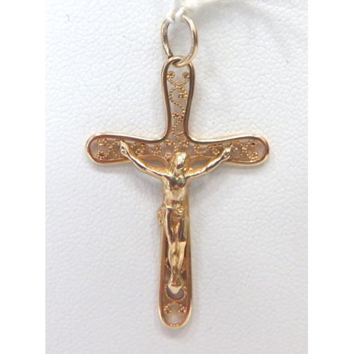 868 - 9ct Yellow Gold Crucifix Pendant which measures 38mm long weighs 1.3g