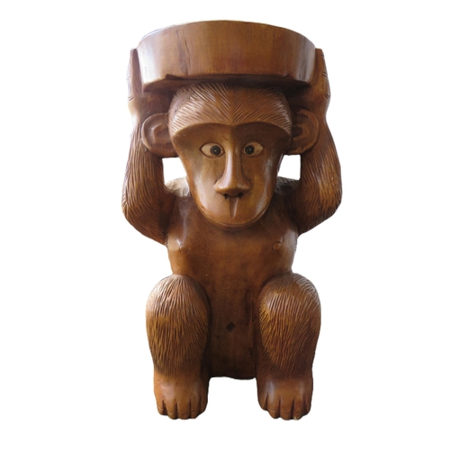 1160 - Carved wooden occasional table or seat in the form of a monkey, 52cm tall.