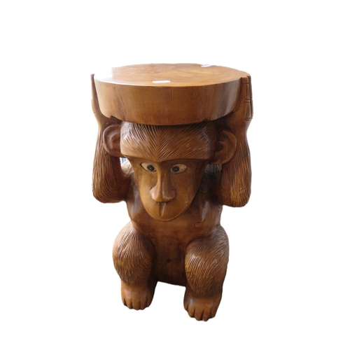 1160 - Carved wooden occasional table or seat in the form of a monkey, 52cm tall.