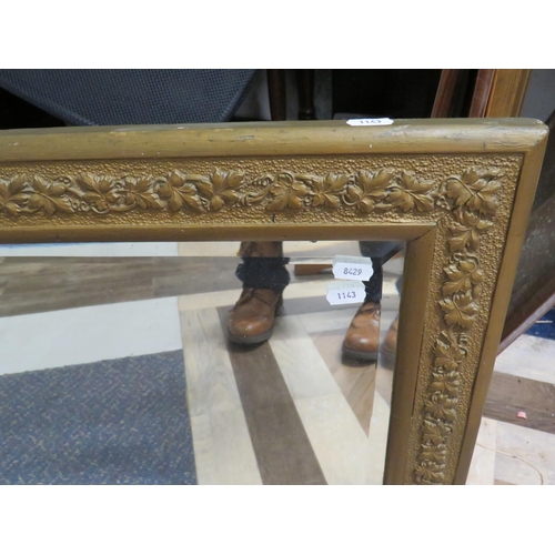 1143 - Large Bevelled Glass mirror with wall fixing lugs and attractive carved gilt frame. Measures 24 x 56... 