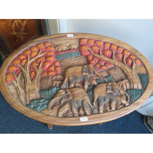 1341 - Nicely Carved wooden table with magazine rack under. Has beautifully carved Elephants to top and sid... 