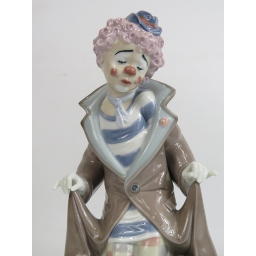 18 - Lladro figurine of a clown with dogs hiding under his coat, model no 5901, approx 25cm tall. With bo... 