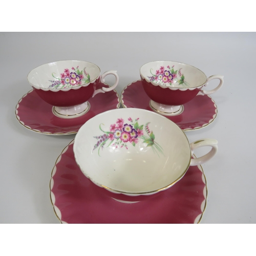 28 - 3 Susie Cooper pink cabinet cups and saucers with floral decoration to the bowl.