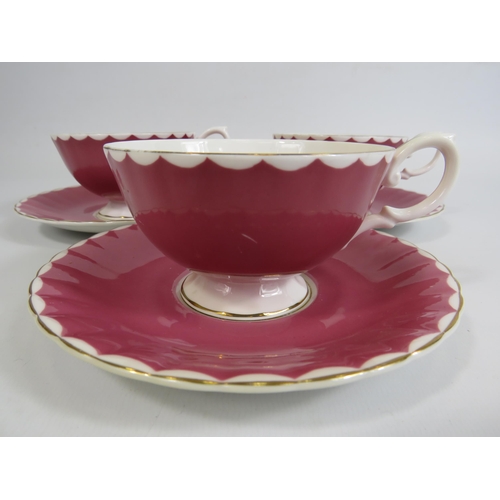 28 - 3 Susie Cooper pink cabinet cups and saucers with floral decoration to the bowl.