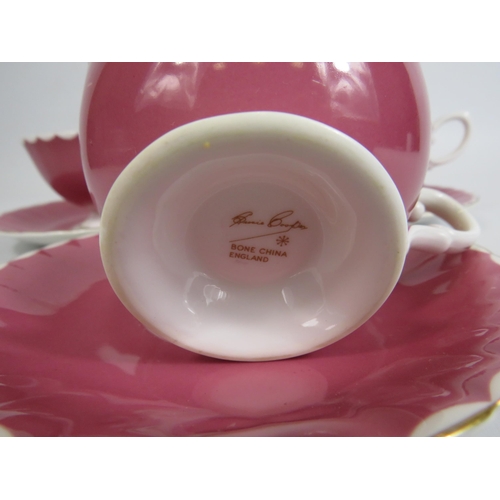 28 - 3 Susie Cooper pink cabinet cups and saucers with floral decoration to the bowl.