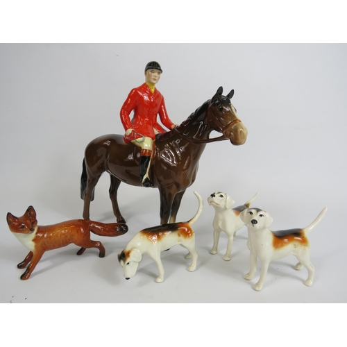 59 - Beswick Huntsman on a bay horse, 3 Hounds and a fox. (one hound has a repair to the tail)