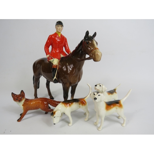 59 - Beswick Huntsman on a bay horse, 3 Hounds and a fox. (one hound has a repair to the tail)