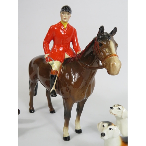 59 - Beswick Huntsman on a bay horse, 3 Hounds and a fox. (one hound has a repair to the tail)