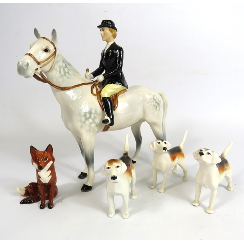 60 - Beswick Huntswomen on grey horse , 3 hounds and a fox.