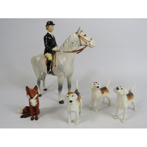 60 - Beswick Huntswomen on grey horse , 3 hounds and a fox.