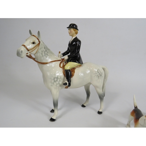 60 - Beswick Huntswomen on grey horse , 3 hounds and a fox.