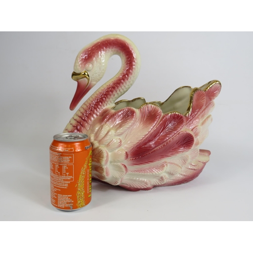 63 - Large Staffordshire pink and gold ceramic swan planter, 31cm tall and 33cm long.