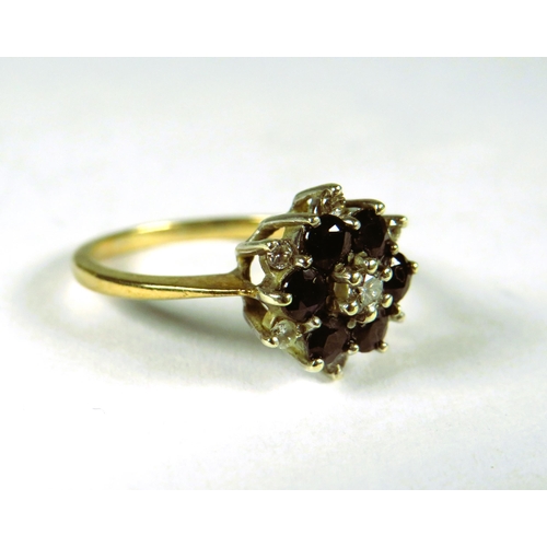 300 - 9ct Yellow Gold Ring set with a small central Diamond with Sapphires and Diamonds in a flower patter... 