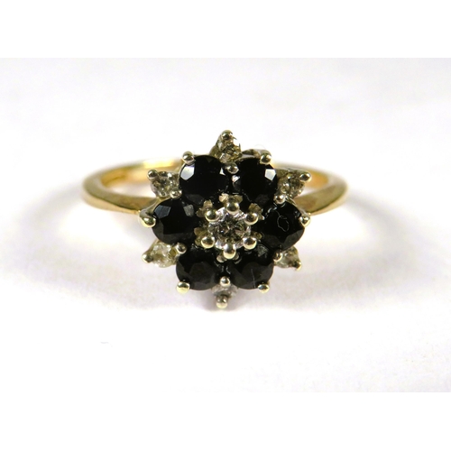 300 - 9ct Yellow Gold Ring set with a small central Diamond with Sapphires and Diamonds in a flower patter... 