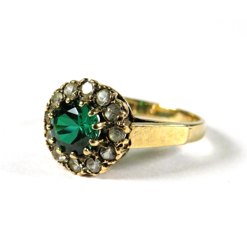 304 - 9ct Yellow Gold Gemstone set ring in flower patter.   Finger size M-5    2.7g