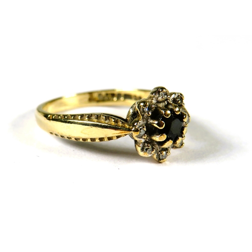 305 - 9ct Yellow Gold ring set with a small Circular Central Sapphire with Diamond surround in a flower pa... 