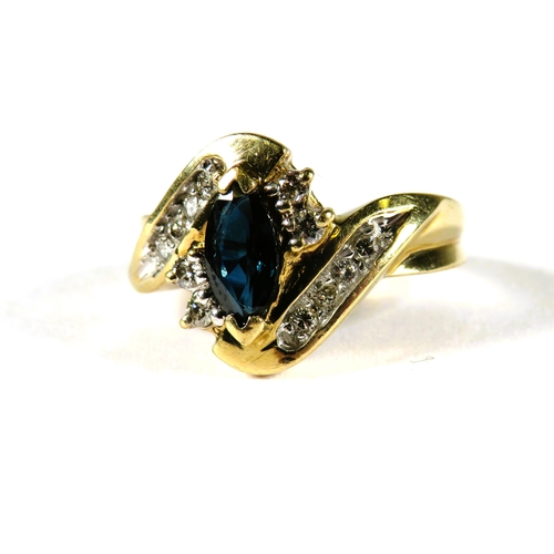 312 - 9ct Yellow Gold ring set with an Oval Central Sapphire, Multiple Diamond surround in a wave pattern.... 