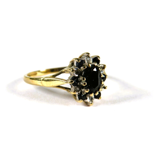 313 - 9ct Yellow Gold ring set with a central Sapphire with sapphire and Diamond surround in a flower patt... 