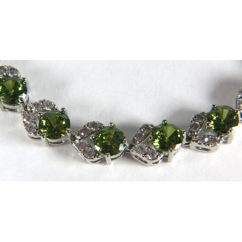 322 - 925 Silver Bracelet, 8 inches with detachable extension. Set with Synthetic Peridot & White Topaz as... 