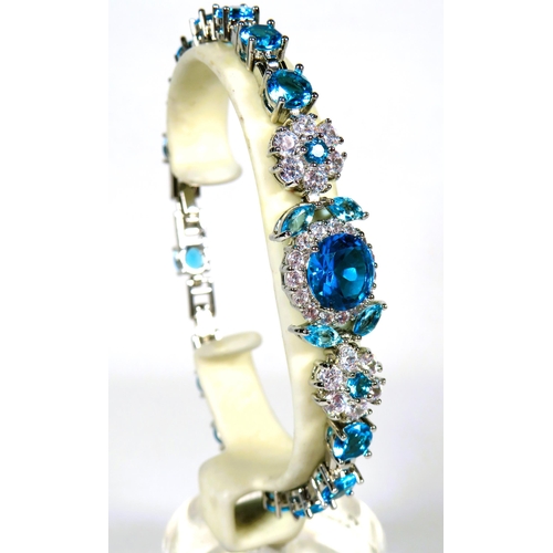 324 - 925 Silver Tennis Bracelet, 8 inches with detachable extension. Set with Synthetic Opal & Topaz.   a... 