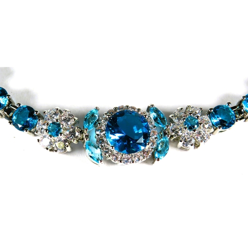 324 - 925 Silver Tennis Bracelet, 8 inches with detachable extension. Set with Synthetic Opal & Topaz.   a... 