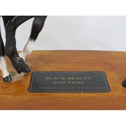 70 - Beswick Connoisseur model of Black beauty and foal standing on a wooden plinth.